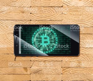 Cryptocurrency concept (A smartphone with a Bitcoin displayed and on the plank)4