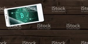 Cryptocurrency concept (A smartphone with a Bitcoin displayed and on the plank)6