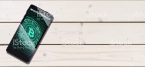 Cryptocurrency concept (A smartphone with a Bitcoin displayed and on the plank)7