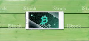 Cryptocurrency concept (A smartphone with a Bitcoin displayed and on the plank)9