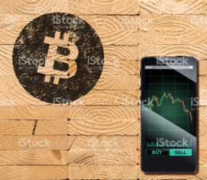 Cryptocurrency concept (A smartphone with Bitcoin chart displayed and on the plank)4