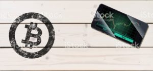 Cryptocurrency concept (A smartphone with Bitcoin chart displayed and on the plank)7